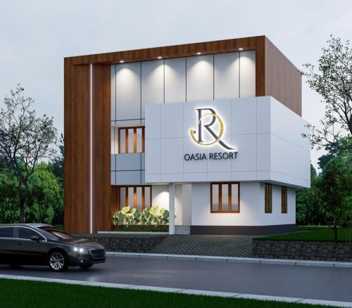 a building with a car parked in front of it at Oasia Resort in Kannur
