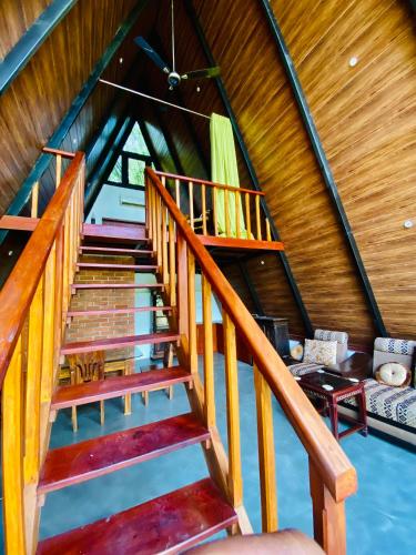 a staircase in a house with wooden ceilings at Agora Field in Hikkaduwa