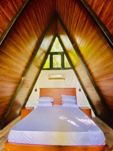 a bedroom with a large bed in a attic at Agora Field in Hikkaduwa