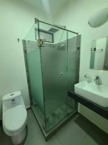 a bathroom with a shower and a toilet and a sink at Depa los robles fracc aldea hortus in Naranjo