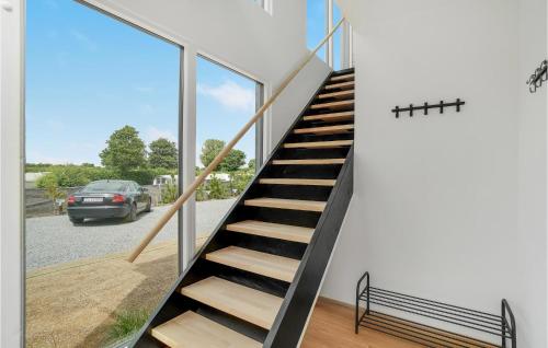 a staircase in a house with glass windows at 2 Bedroom Cozy Apartment In Kerteminde in Kerteminde
