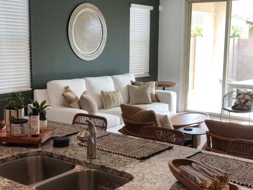 a living room with a white couch and chairs at Sosegado at The Parks in Queen Creek