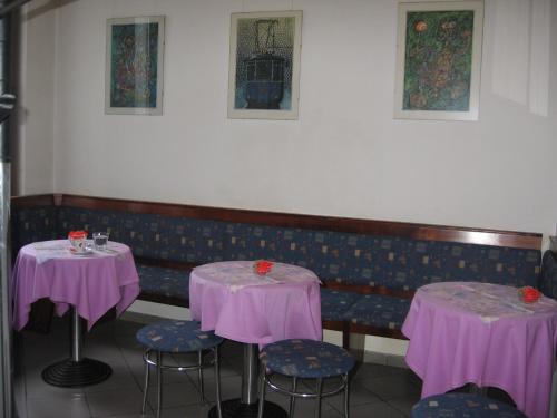 a room with two tables and chairs with purple table cloth at Guest House Rože in Ilirska Bistrica