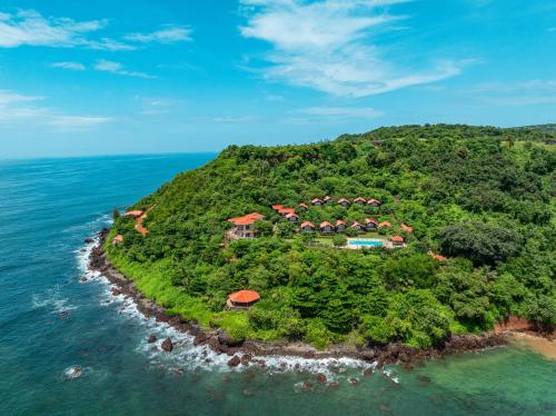 an island in the ocean with a resort at Highland Sarovar Portico Sindhudurg in Bhogwe