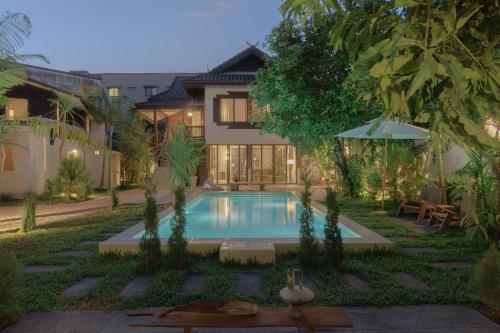 a swimming pool in the backyard of a house at Private Pool, 8-Bedroom, Old Town, Entire Estate - TANPURI Thapea - Prime Location in Chiang Mai