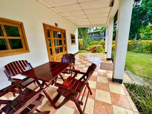 a wooden table and chairs on a patio at Hospedaje Soma in Moyogalpa