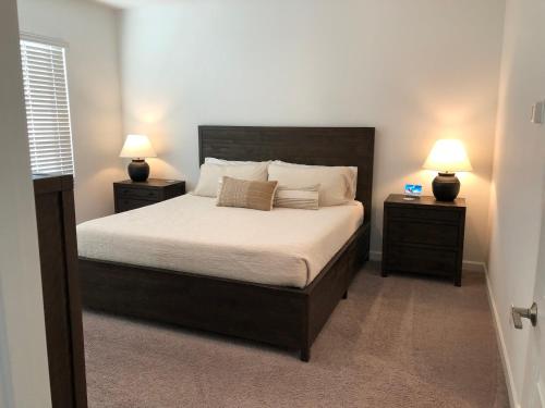 a bedroom with a large bed with two night stands at Sosegado at The Parks in Queen Creek