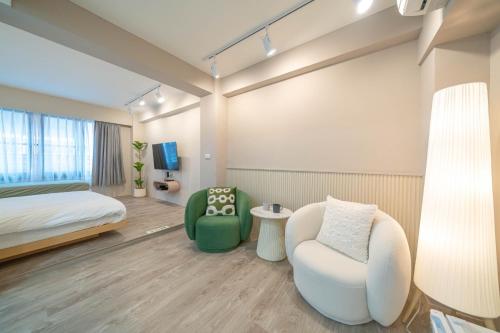a hotel room with a bed and a chair at Tsum chill in Tainan