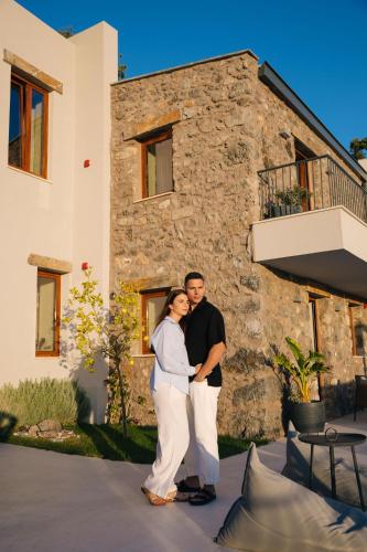 a man and a woman standing in front of a building at Mirthea Suites in Mírthios