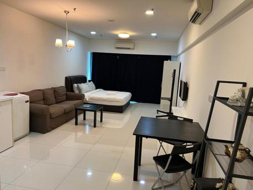 a living room with a couch and a table at SP Home At Mercu Summer Suites in Kuala Lumpur