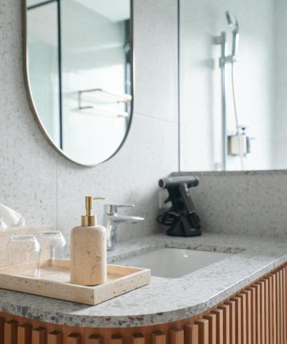 a bathroom counter with a sink and a mirror at Walk in House in Yuanshan