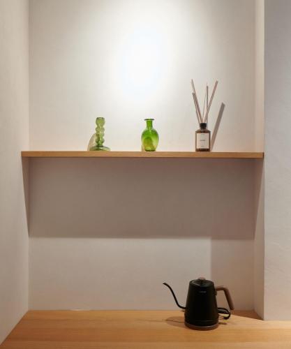 a shelf with a tea kettle on a wooden floor at Walk in House in Yuanshan
