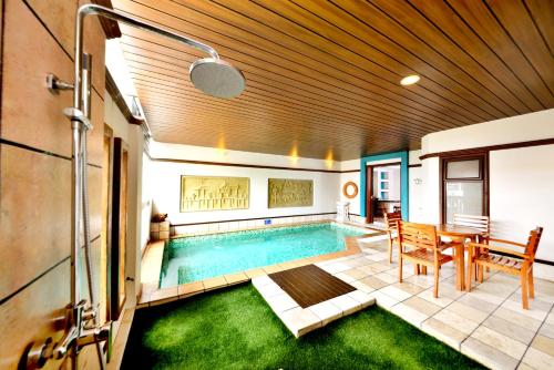 a swimming pool in the middle of a house at Grand Lexis Port Dickson in Port Dickson