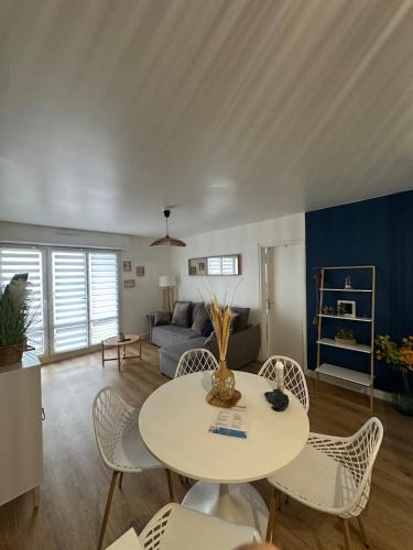 a living room with a table and chairs at Comme à la maison in Saint-Brieuc