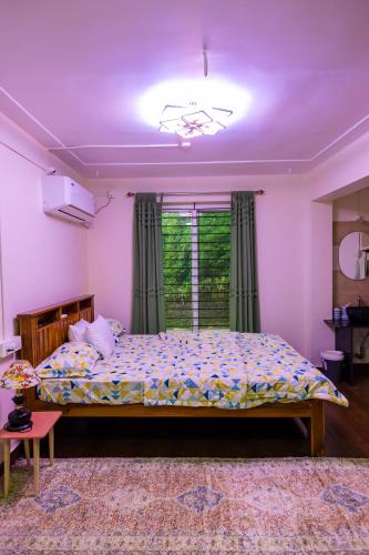a bedroom with a bed and a purple ceiling at Cocobaba Farmstay in Kumta