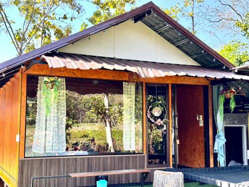 a house with a large window on the front of it at Nansilarom in Ban Bun Yun
