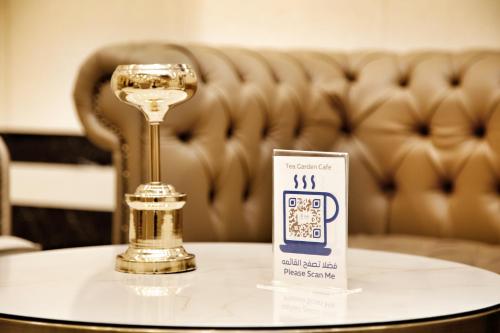 a table with a wine glass on top of it at MADEN Al Rawda مادن الروضة in Al Madinah