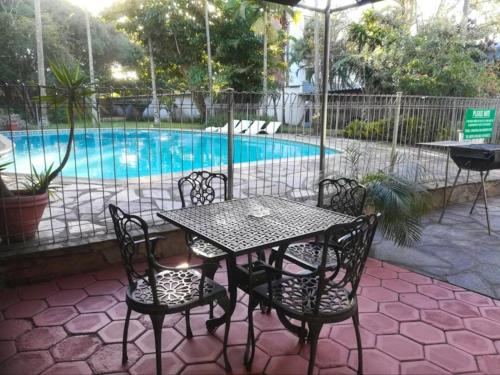 a table and chairs in front of a swimming pool at The Bay View Hotel in Richards Bay