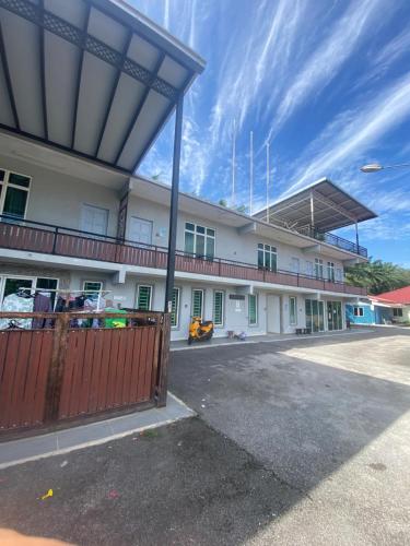a white building with a red fence in front of it at DD Empire Homestay in Jeram