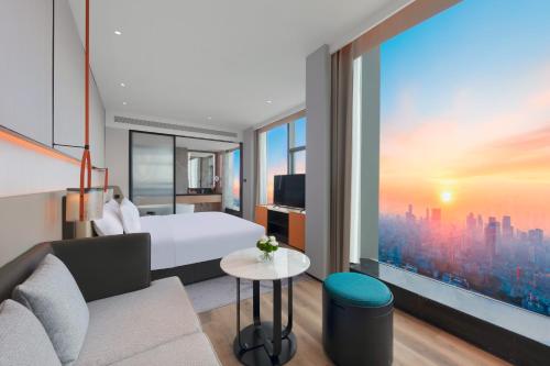a hotel room with a bed and a large window at Crowne Plaza Taizhou City Center by IHG in Taizhou