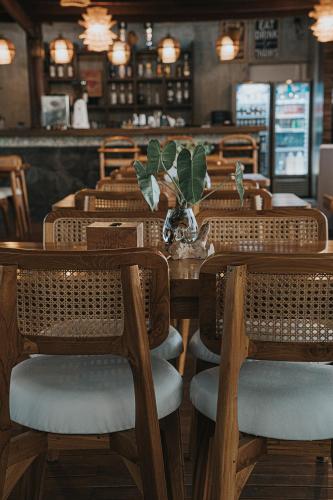 a dining room with wooden tables and chairs at MaxOneHotels at Ubud - CHSE Certified in Ubud