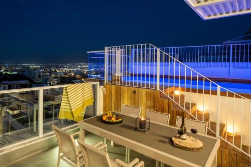 a balcony with a table and chairs on a building at Penthouse Salomon cliffs in Eilat