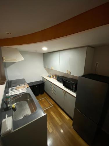 a kitchen with a sink and a counter top at KUMANO家-CoCo- in Shingu