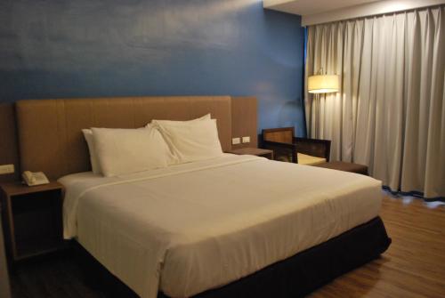 a bed in a hotel room with a large white bed at Cebu Grand Hotel in Cebu City