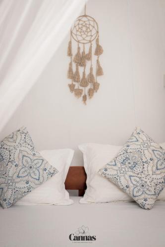 a bedroom with a bed with pillows and a chandelier at Cannas Hiri in Dickwella