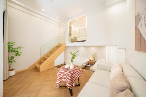 a living room with a couch and a table at Tonight Homestay Jing'an Temple Branch Shanghai in Shanghai