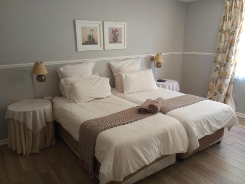 Ένα ή περισσότερα κρεβάτια σε δωμάτιο στο Lilac Lodge