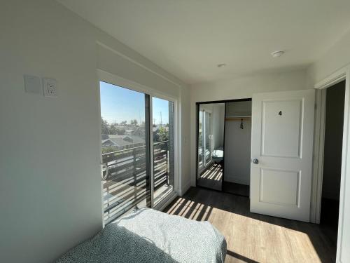 a bedroom with a bed and a large window at Blue Stay Walk to BMO Stadium and USC in Los Angeles