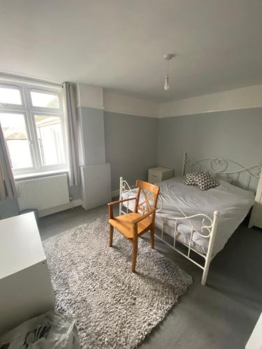 a bedroom with a bed with a chair and a rug at Contractors Rooms In Fawley in Fawley