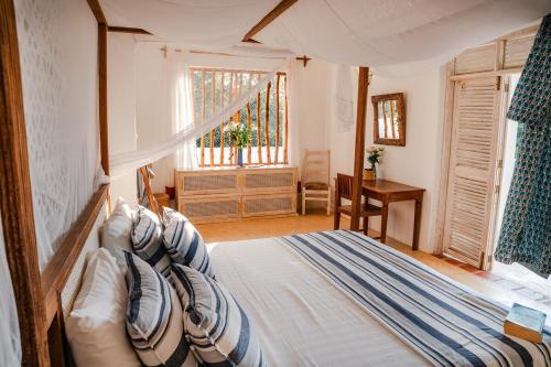 a bedroom with a bed and a window at Villa Maridadi in Ukunda Airport