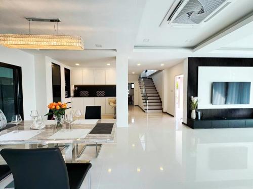 a living room with a dining table and a kitchen at aSU villa in Ban Huai Yai