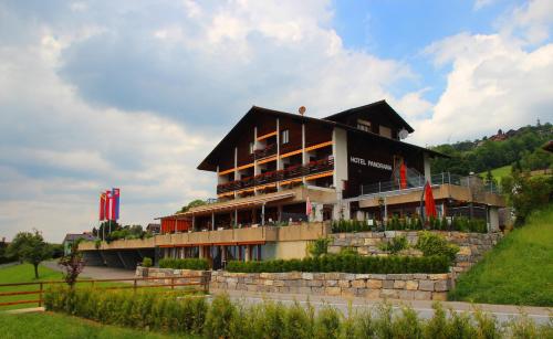 a large building on top of a hill at Hotel Restaurant Panorama in Aeschlen