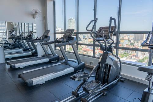 a row of treadmills in a gym with windows at Parc21 Luxury Boutique Hotel in Phnom Penh