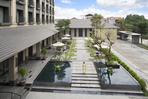 an external view of the courtyard of a building at Modena by Fraser Vinh Yen in Yen