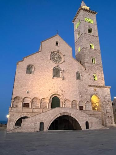 a building with a tower with a clock on it at B&B Villa Mediterranea with parking space in Trani