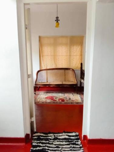 a bedroom with a bed in a room with a rug at No 06 Veediya Bandara Lane Bahirawakanda in Kandy