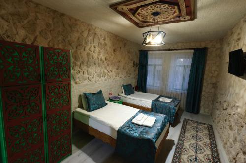 Кровать или кровати в номере KEMAL STONE HOUSE HOTEL.