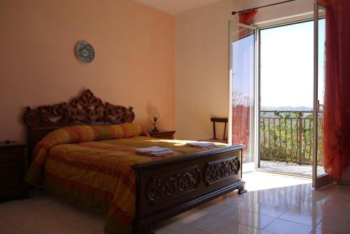 a bedroom with a bed and a sliding glass door at Casa Vacanze Laura in Caltanissetta