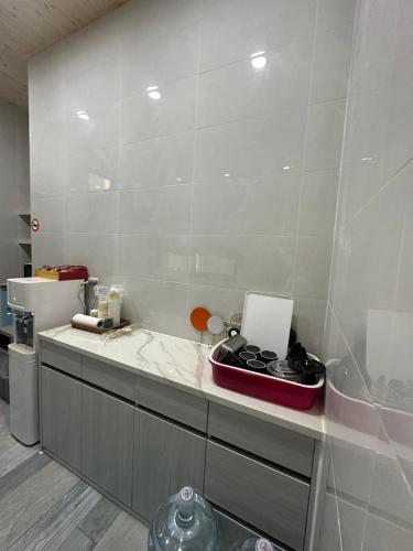 a kitchen with a white counter top with a counter top at One third of an acre B&B in Magong