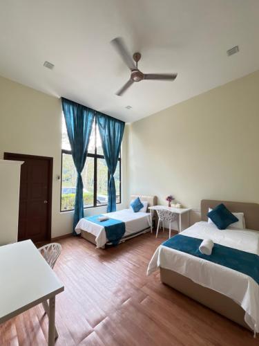 a bedroom with two beds and a ceiling fan at Forest Lodge, Radiant Janda Baik in Bentong