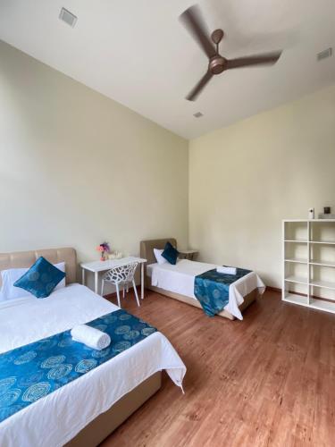 a bedroom with two beds and a ceiling fan at Forest Lodge, Radiant Janda Baik in Bentong