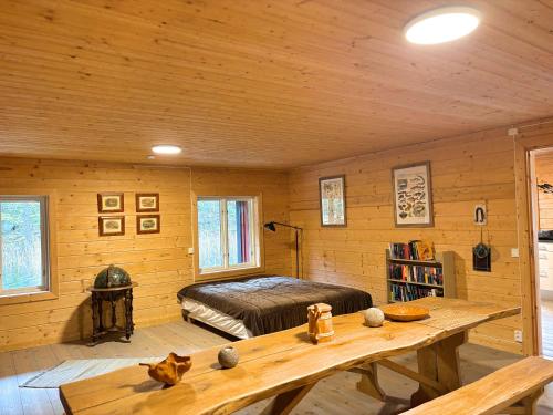 a bedroom with a bed and a table in a room at Hus Upplångö in Figeholm
