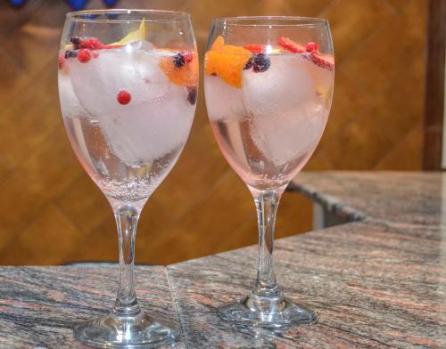 two wine glasses with fruit in them on a table at Hotel Malena in Caravaca de la Cruz