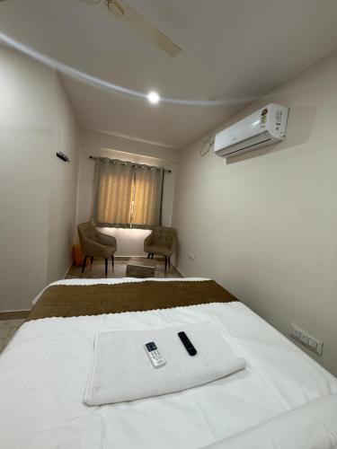 a bedroom with a bed with a towel on it at Vaaraahi Hotels in Hyderabad
