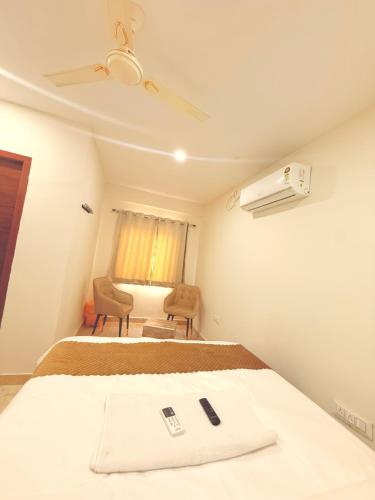 a bedroom with a bed with two remote controls on it at Vaaraahi Hotels in Hyderabad