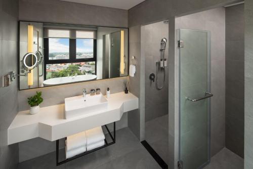 a bathroom with a sink and a shower at Modena by Fraser Vinh Yen in Yen
